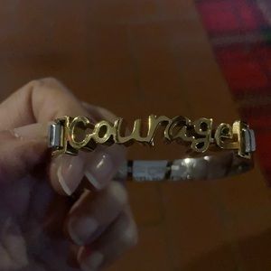 Rustic cuff bracelet with “courage” written in it in gold